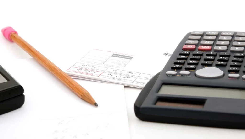 pencil and paper with a calculator